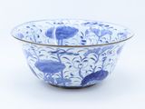 a blue and white bowl sitting on a white surface