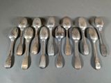 six spoons are arranged in a row on a gray surface