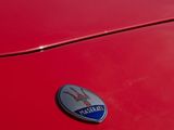 the front end of a red sports car parked in a parking lot