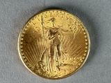 a close up of a gold coin with a woman holding a flag