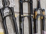 many different types of fishing rods on the ground