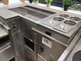 a kitchen with a lot of stainless steel counter tops