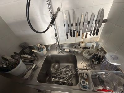 a kitchen sink with a lot of utensils in it