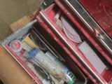 a red tool box sitting on top of a wooden table