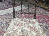 a chair that is sitting on a rug on the floor