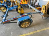 a blue trailer with a yellow sign on it in a garage