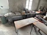 many tables and chairs in a room with a lot of clutter
