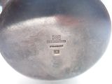 a close up of a metal object on a white surface