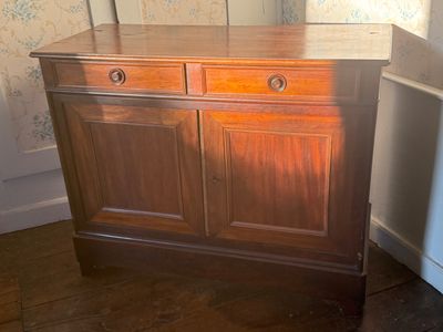 a wooden cabinet with a mirror on top of it