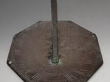 clock with roman numerals on it on a white surface