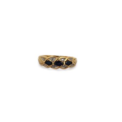 an image of a gold ring with three sapphire stones