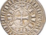 une vieille pièce d'argent ornée d'une croix