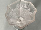 a glass vase with a design on it on a table