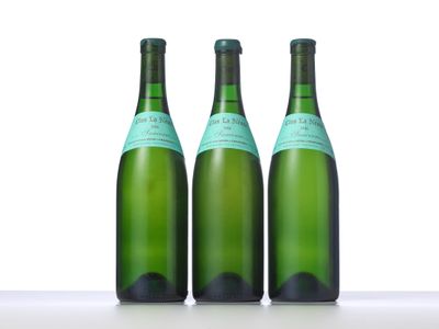 three bottles of wine are lined up on a table