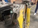 a machine that is sitting on a stand in a warehouse