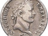 a close up of a coin with a man ' s head on it