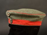 a green hat with a red stripe on it