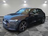 a grey audi suv parked in a garage with a checkered floor