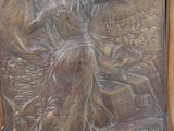 a plaque of a woman on a boat with a man on it