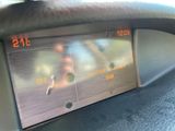 a digital clock on the dashboard of a car