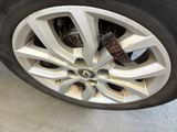 the tire of a car with a sticker on it ' s rim