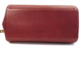 the red leather case is open and ready to be used as a makeup bag