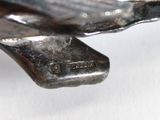 a close up of a metal object on a white surface