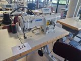 a sewing machine that is sitting on a table in a room
