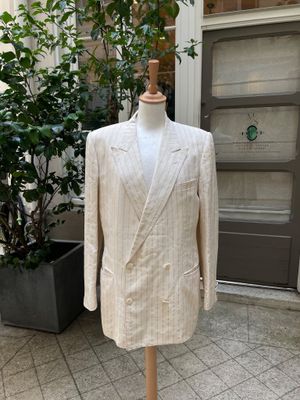 a suit on a mannequin stand outside a building