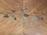 a picture of a wooden table with a floral design on it