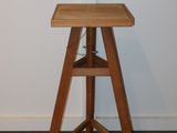 a small wooden table with a shelf on it