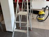 a ladder that is sitting in the middle of a room