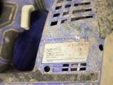 a close up of a blue power drill on a table