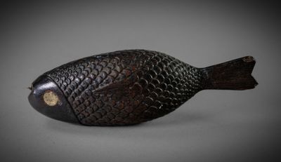 a small wooden fish that is sitting on a table