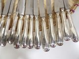 a lot of silverware in a basket on a table