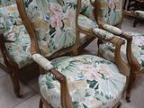 four chairs that are sitting on a tile floor