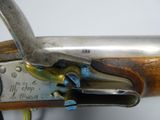 an old gun with a metal handle and a wooden handle