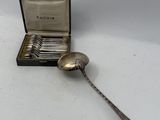 a silver spoon and a silver spoon in a box