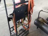 a cart that has a bunch of hoses on it