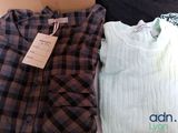 two shirts that are sitting next to each other on a bed