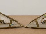 two triangle shaped glass pieces on a table