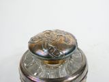 a silver box with a lid on a white surface