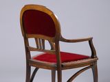 an image of a wooden chair with a red cushion on top of it
