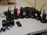 many cell phones and other electronic devices on a table