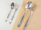 two forks and two spoons sitting on a table