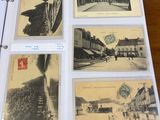 many old postcards on a binder on a table