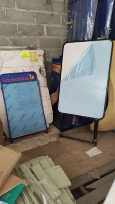 a mirror sitting on top of a table next to a pile of boxes