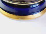 a blue and gold clock on a white table
