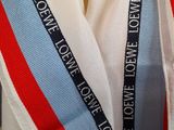 a scarf with a red, white, and blue ribbon on it