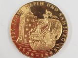 an image of a gold coin with a picture of a ship on it